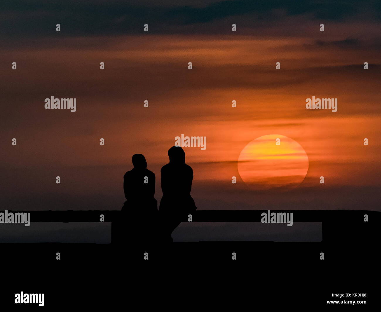 Couple Silhouette Watching the Sunset Stock Photo - Alamy