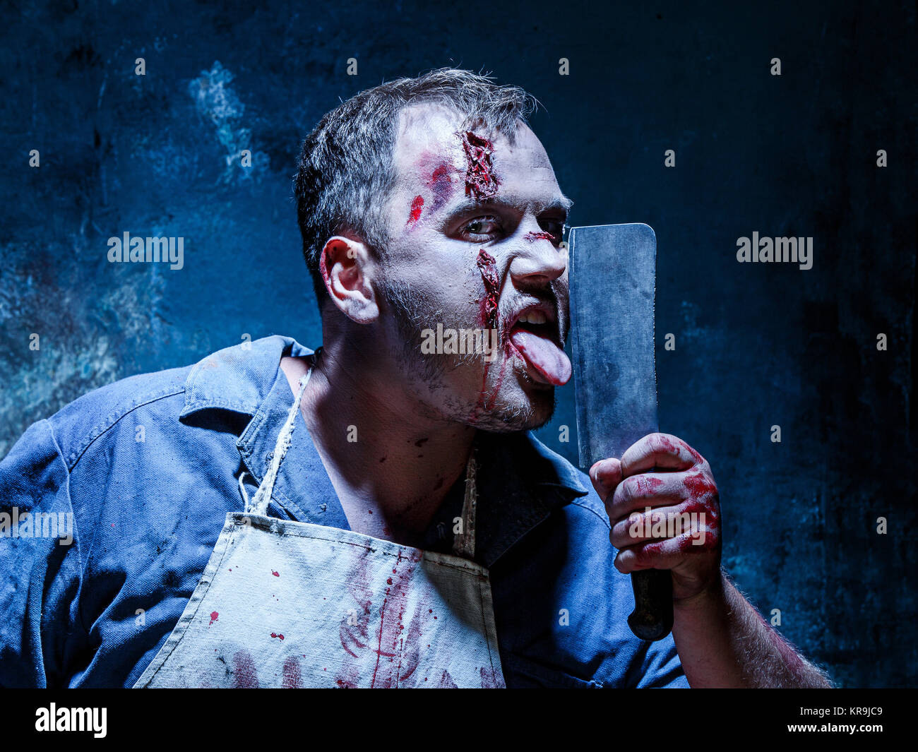 Bloody Halloween theme: crazy killer as butcher with a knife Stock Photo