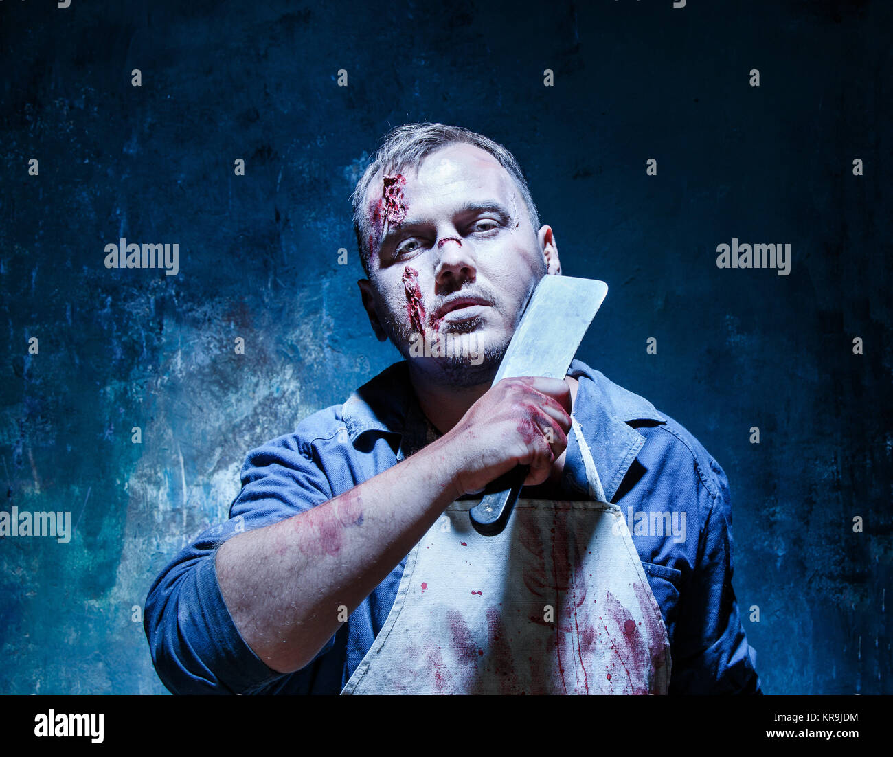 Bloody Halloween theme: crazy killer as butcher with a knife Stock Photo