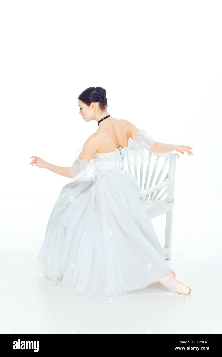 Ballerina in white dress sitting, studio background Stock Photo - Alamy
