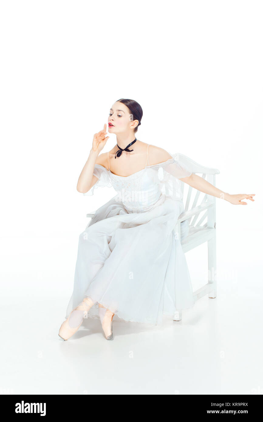Ballerina in white dress sitting, studio background Stock Photo - Alamy