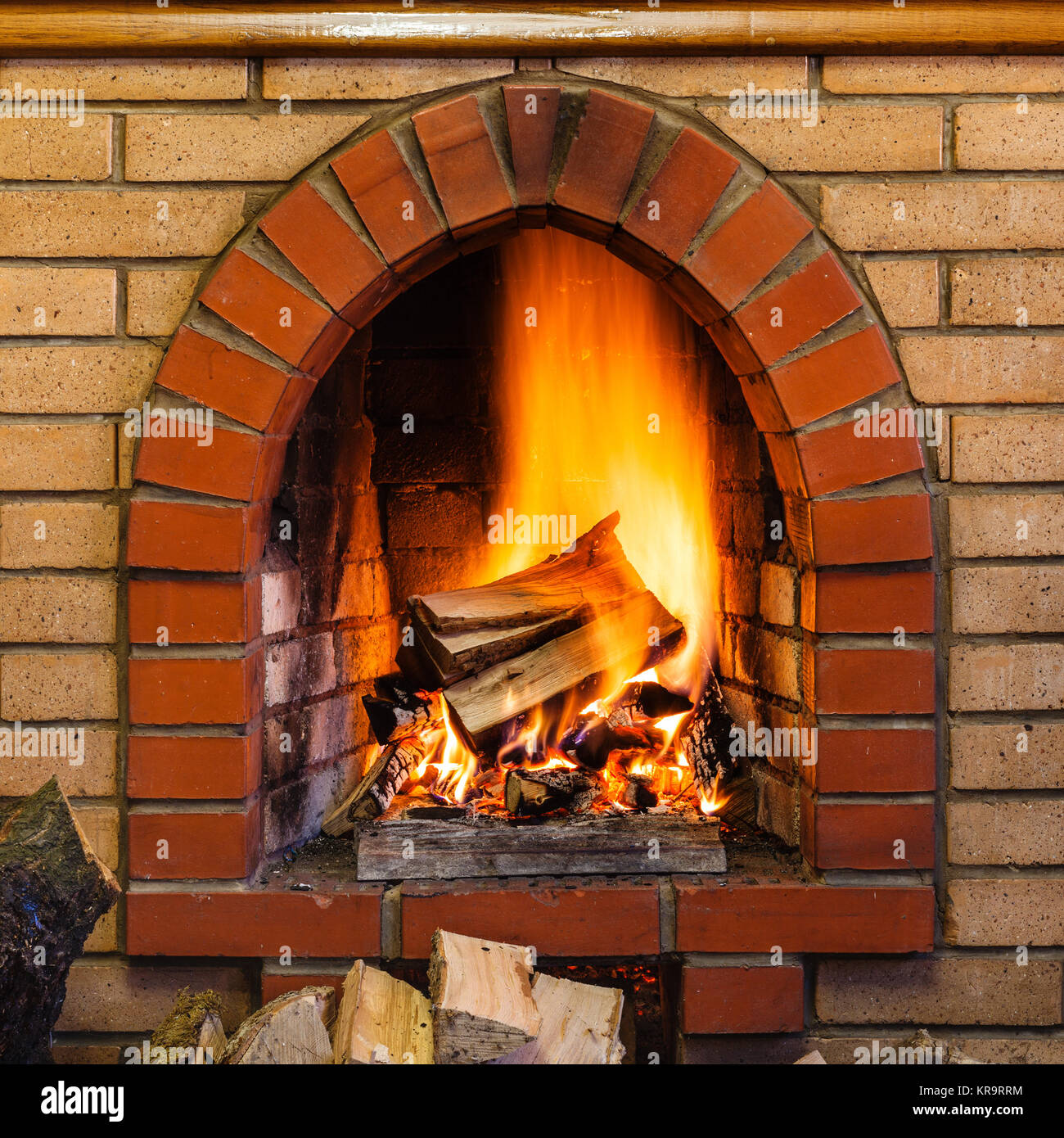 wood burning in indoor brick fireplace Stock Photo - Alamy