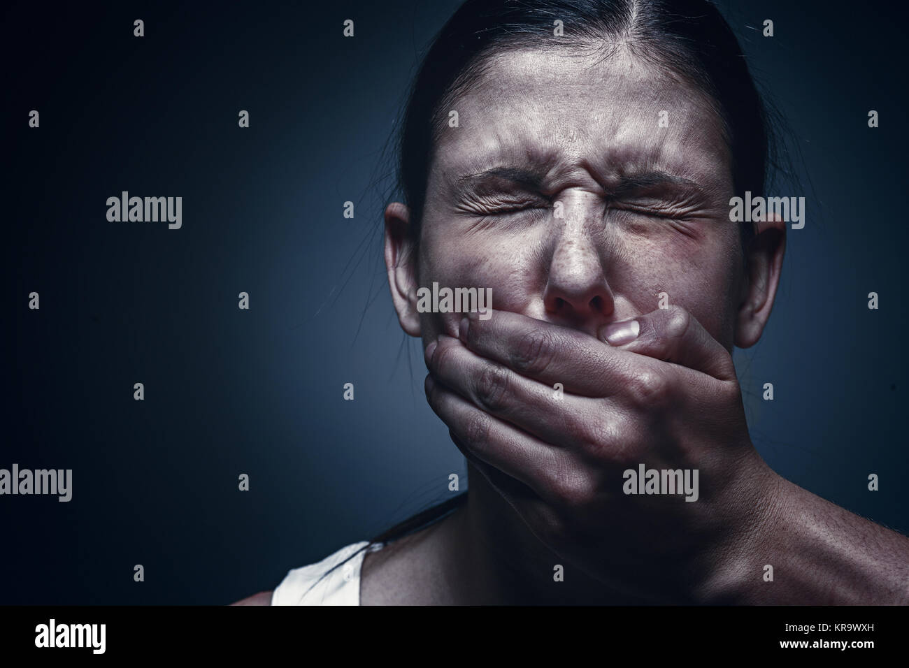 Man covering young woman's mouth Stock Photo Alamy
