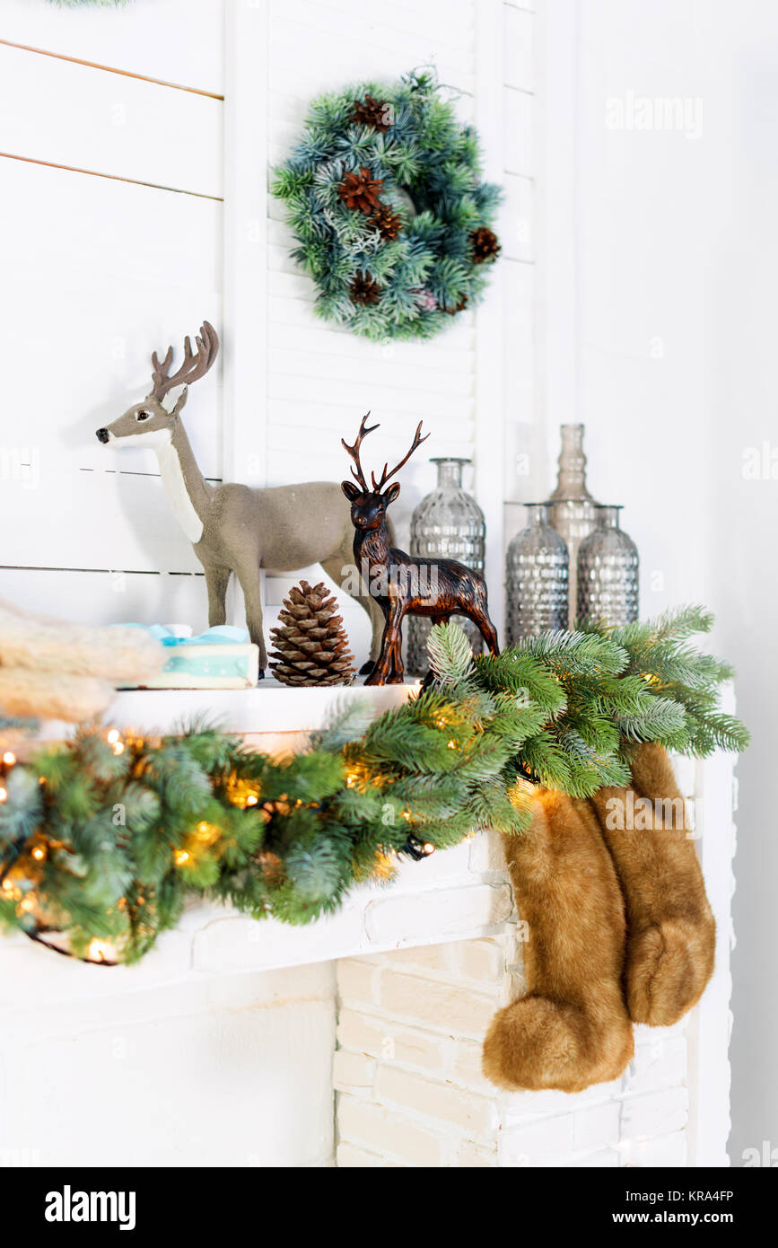 Mantelpiece with Christmas decorations. Cozy winter scene. White