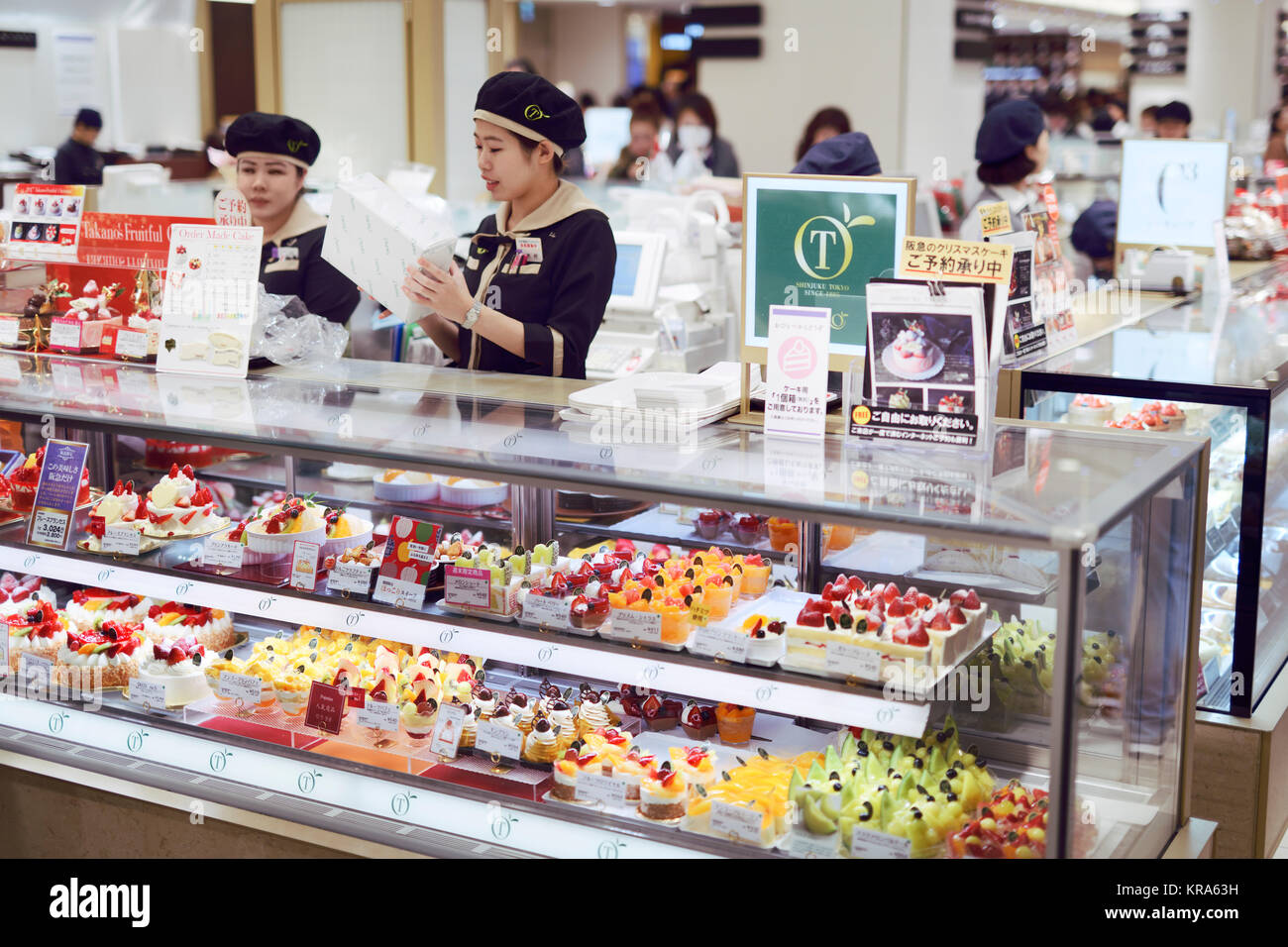 Patisserie shop food stand with cakes and desserts on display in a