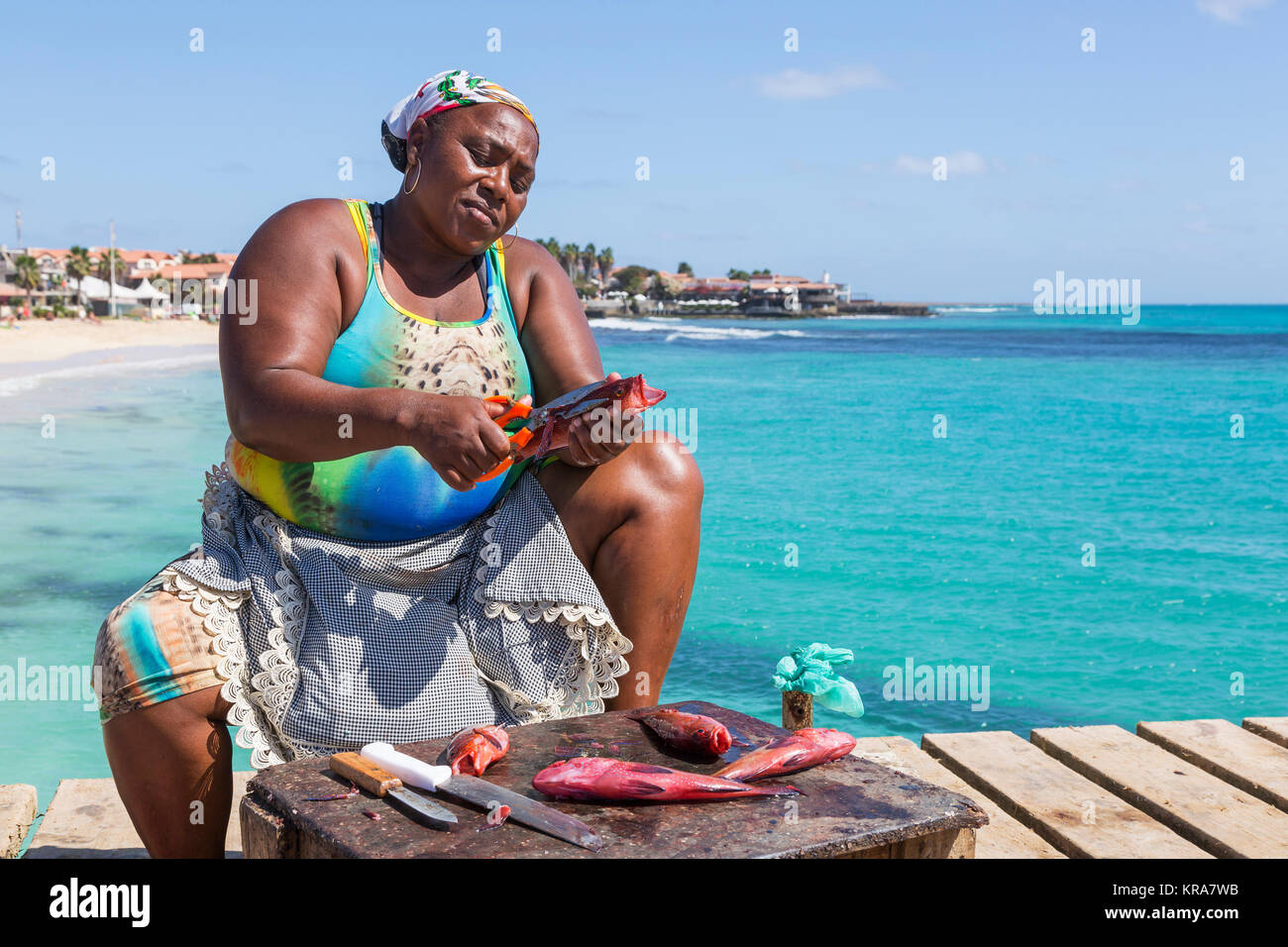 Local woman from Santa Maria, Sal Island, Salina, Cape Verde, Africa gutting and preparing freshly caught fish Stock Photo