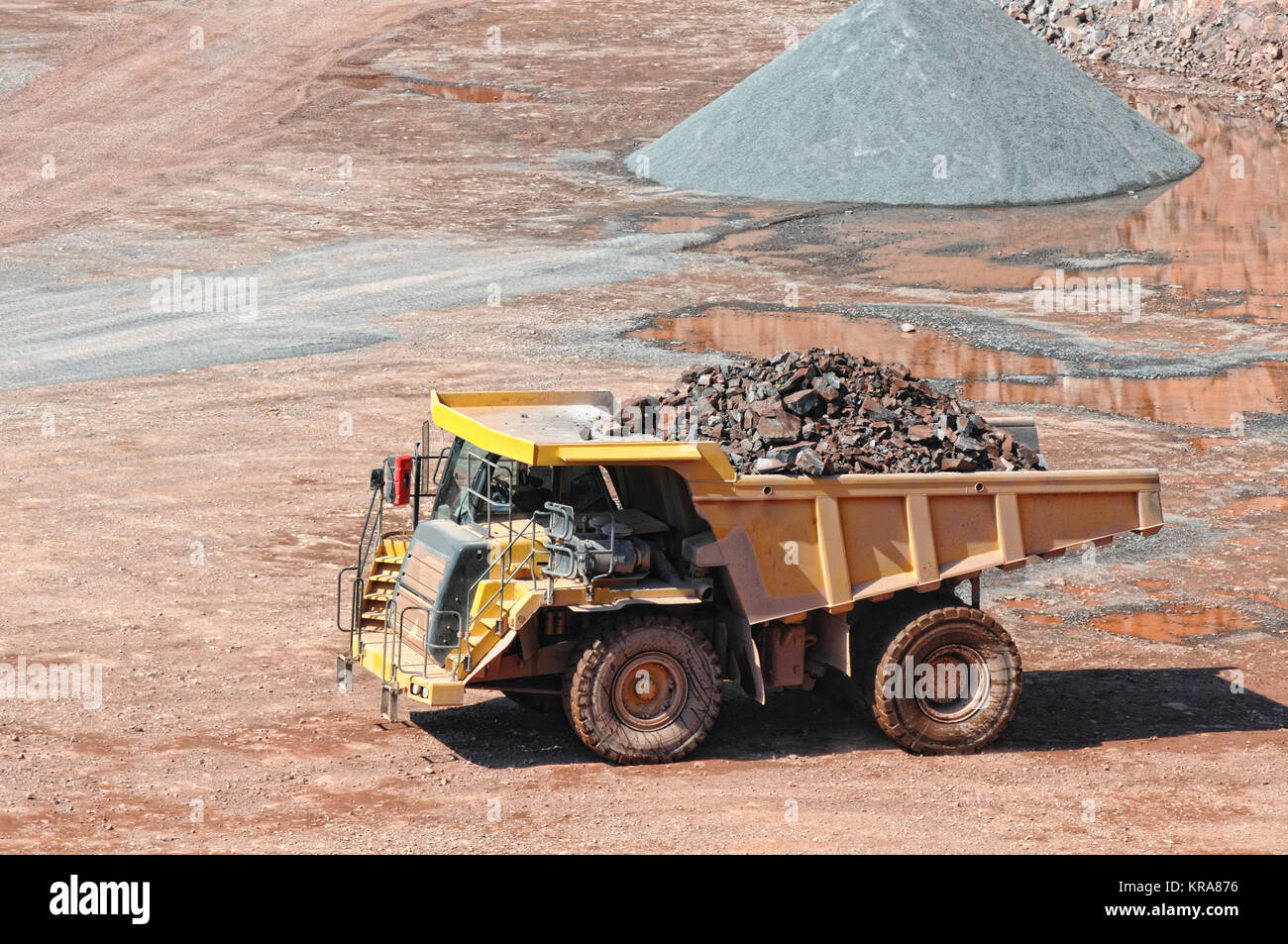 dumper truck carrying porphyry rocks through a quarry mine Stock Photo ...