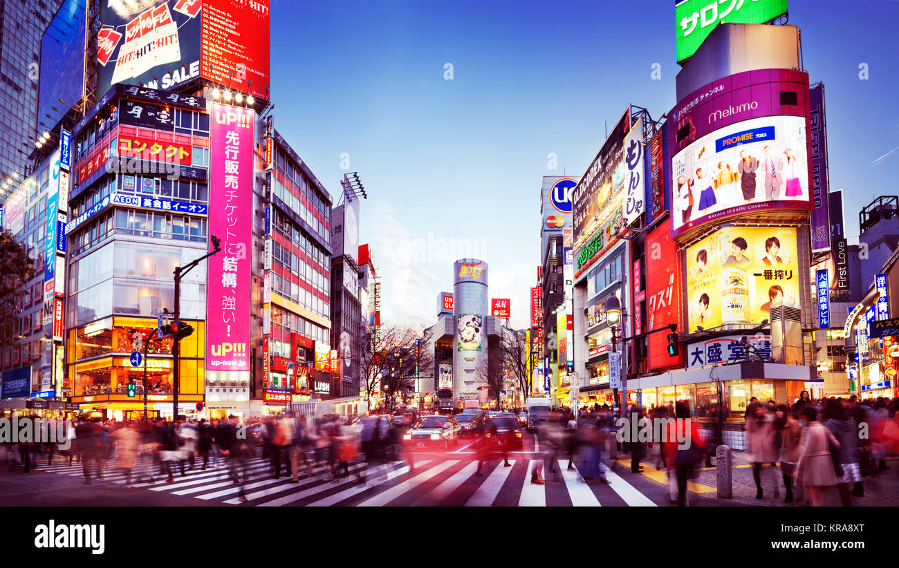 Rush hour at the Tokyo's busiest intersection, Shibuya station crossing, full of people and colors during sunset in Tokyo, Japan. 2014. Artistic motio Stock Photo