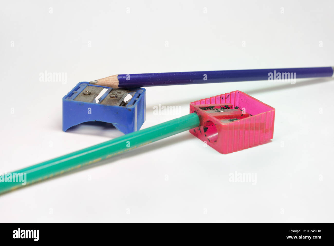 pencil sharpeners and two pencils: green and blue Stock Photo