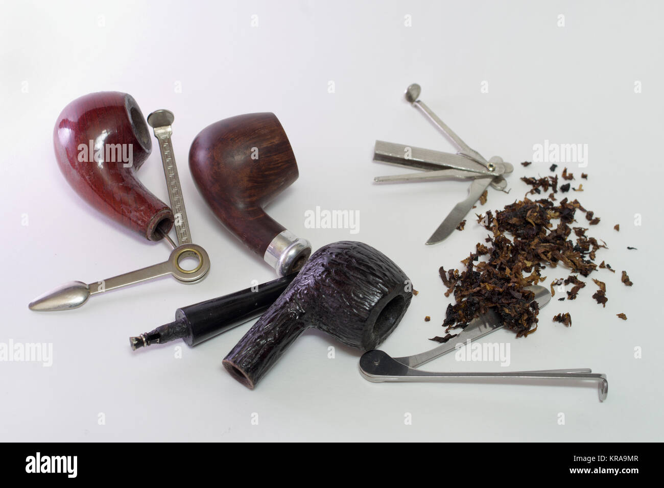 set of tools for smoking pipes. Three dismantled wooden smoking pipes