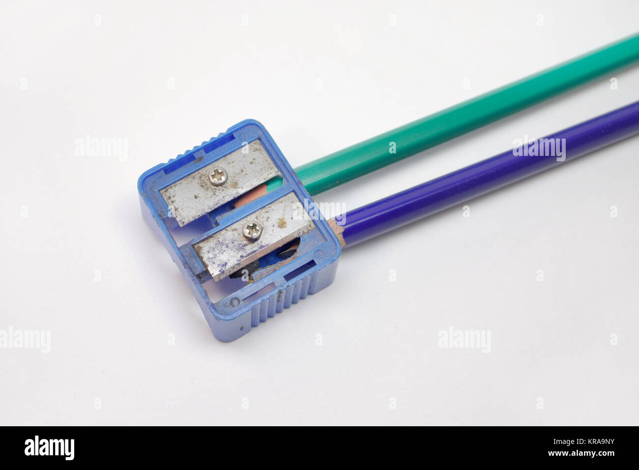 pencil sharpeners and two pencils: green and blue. Closeup Stock Photo