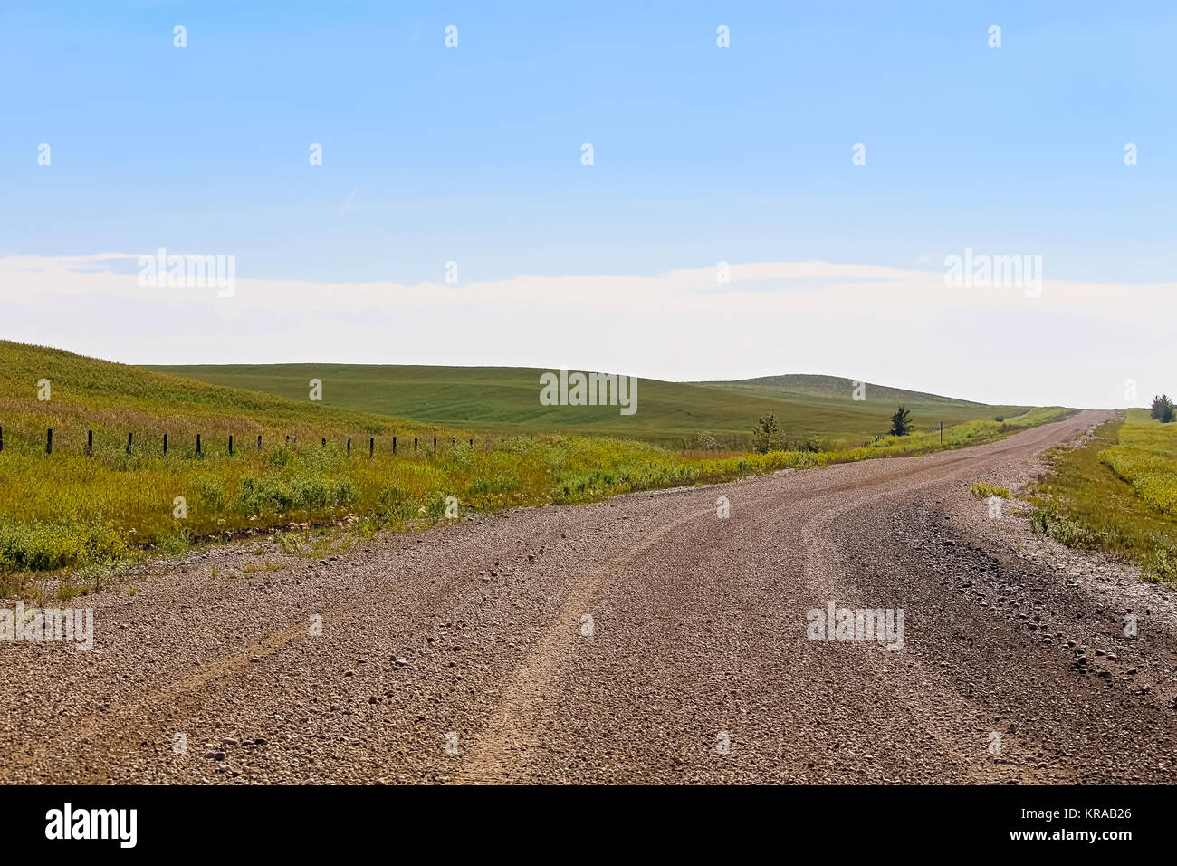 a-gravel-road-through-alberta-farmland-a