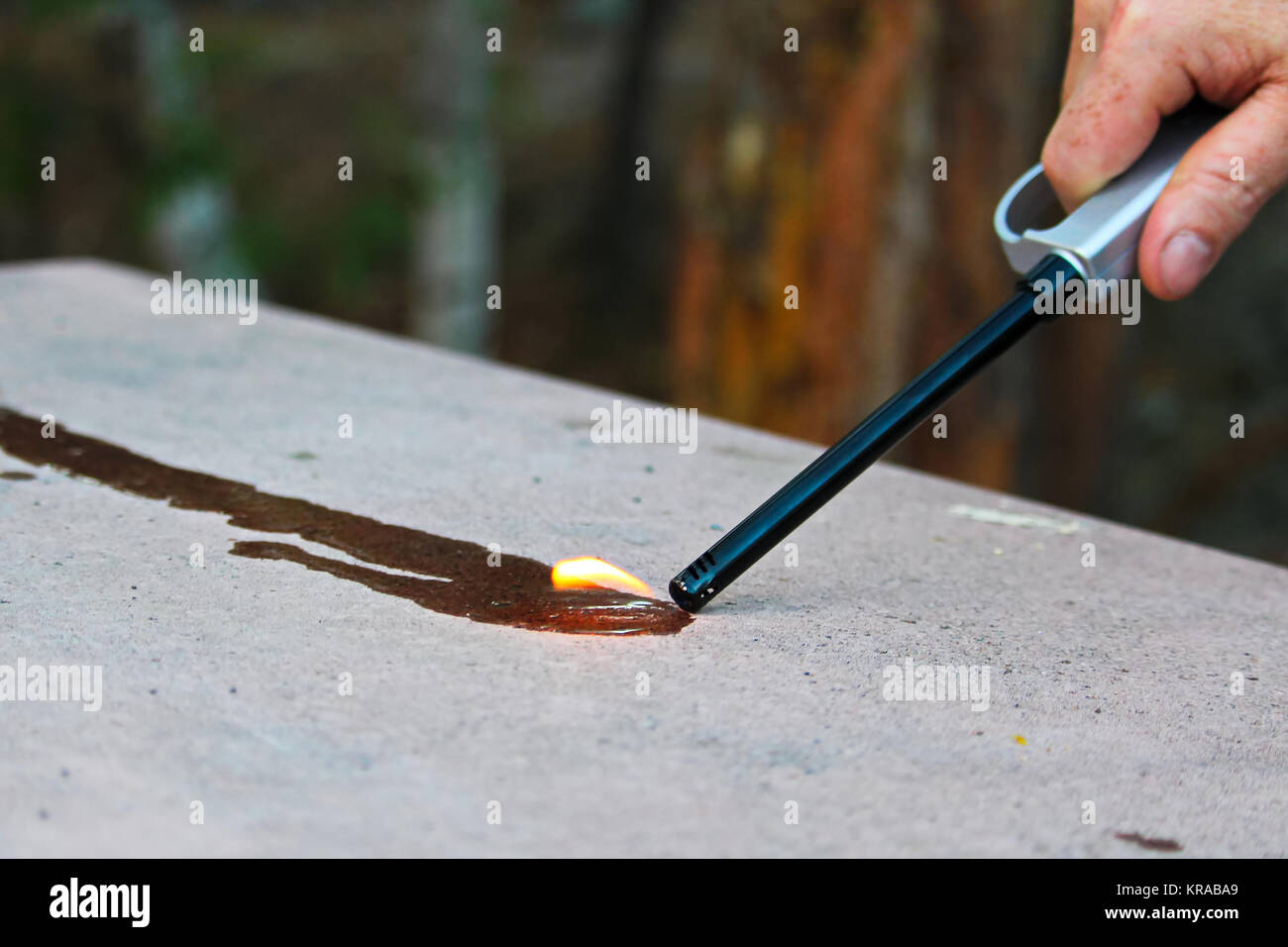 Trying to light fluid on fire with a butane lighter Stock Photo Alamy