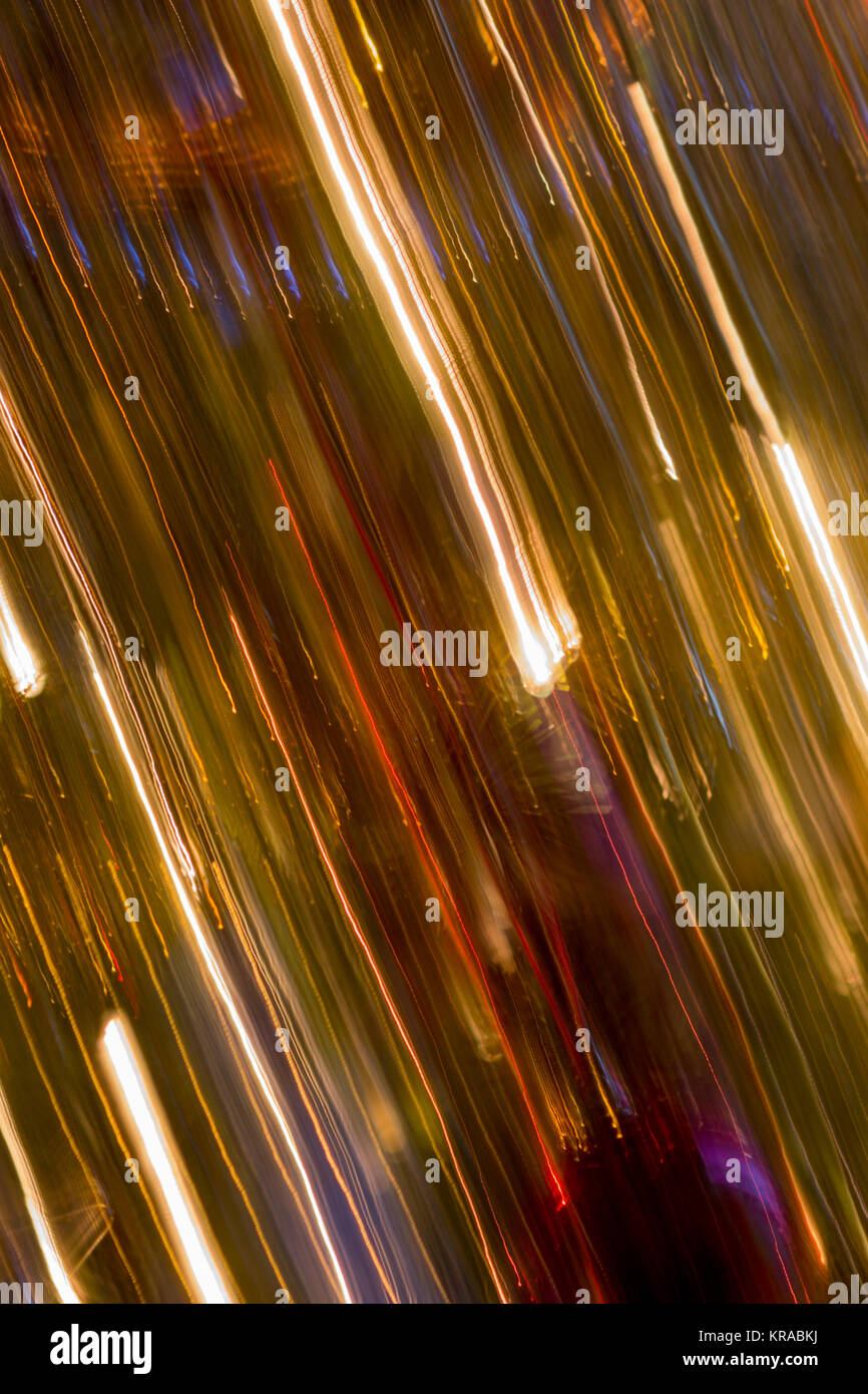 Alternating bright lines, colourful lines and golden lines - vertical panning of Christmas tree with baubles and lights Stock Photo