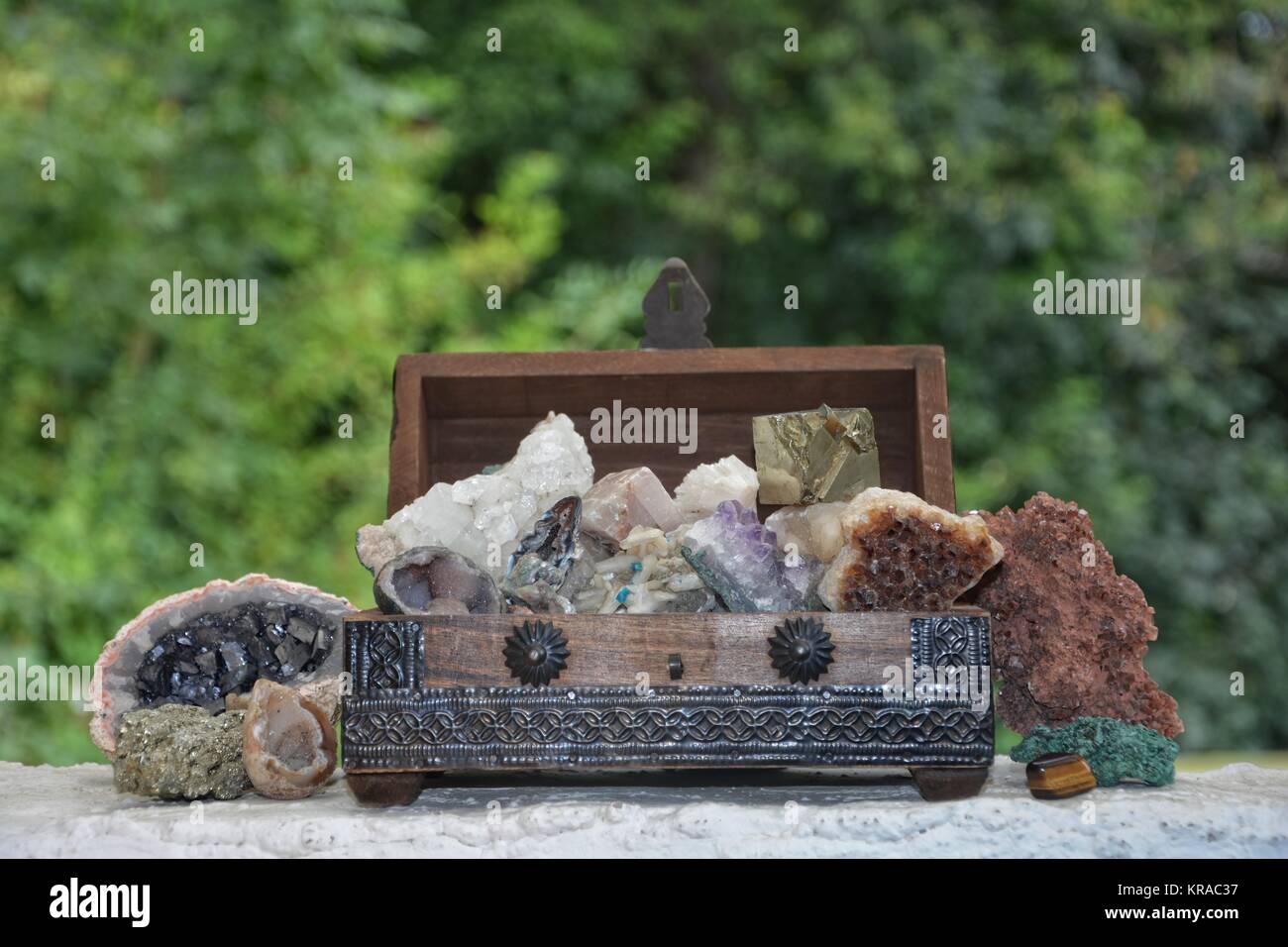 many minerals quartz and crystal stones in wooden box Stock Photo