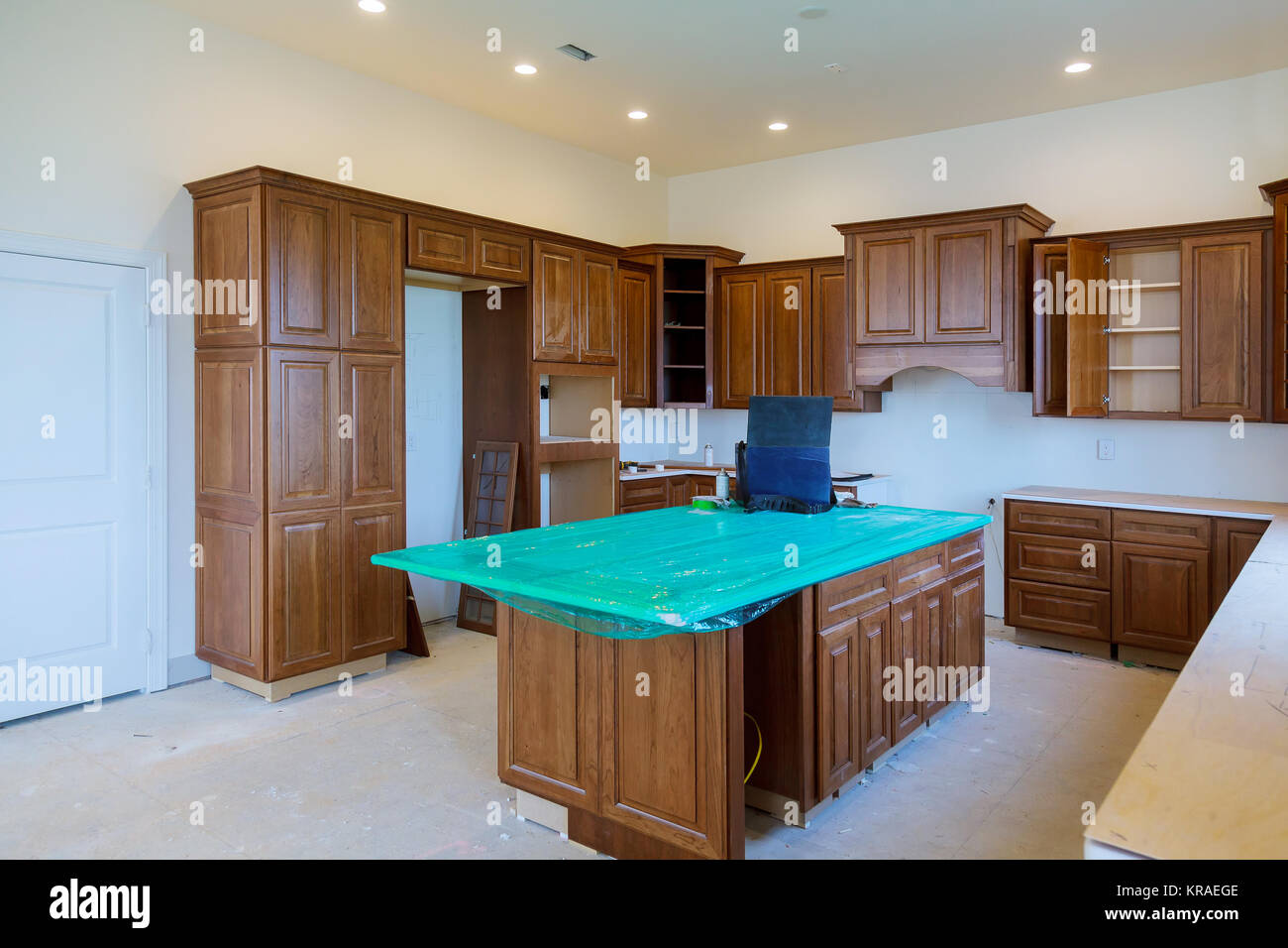 Custom kitchen in various stages of installation base for island in center Installation