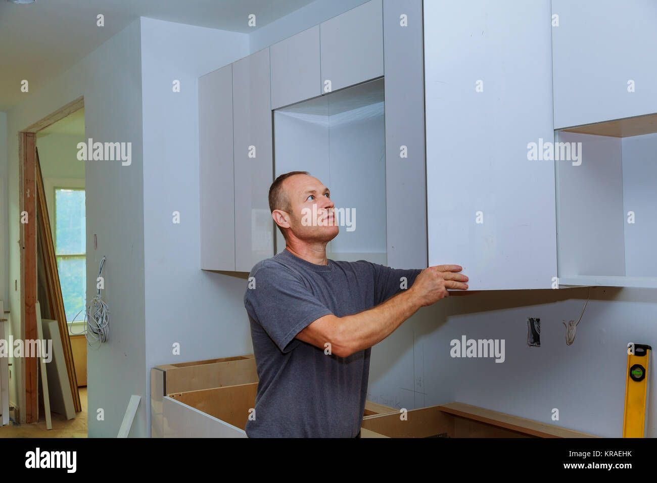 Closeup of a installer installing hardware on new kitchen