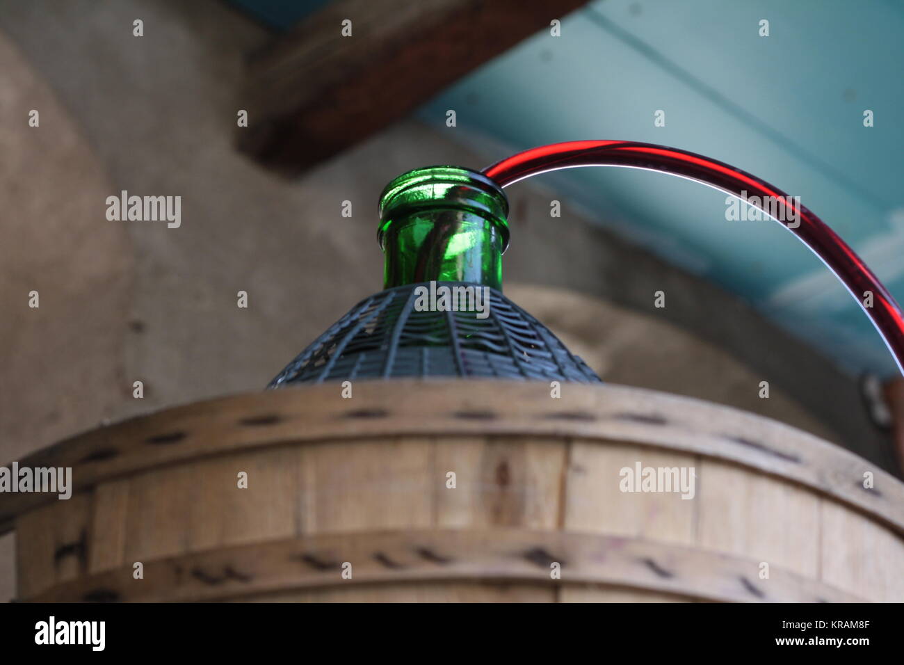 Siphon wine to a demijohn, carboy. Wallpaper, background. With copy