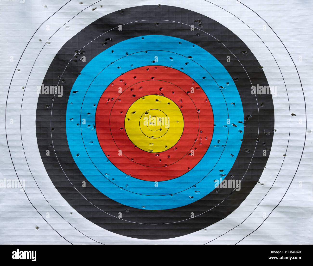 colored paper target with many hits from archery Stock Photo