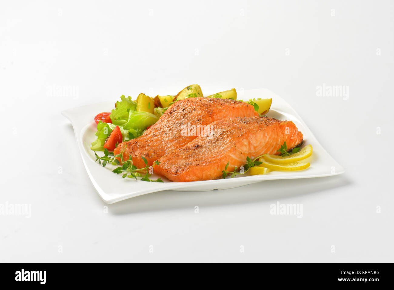 dish of salmon fillets with roasted potatoes Stock Photo Alamy