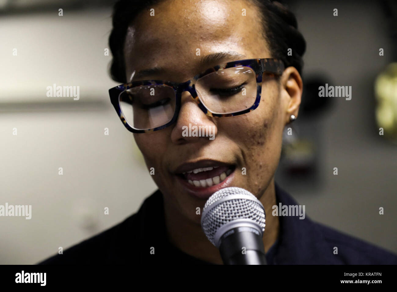 OCEAN (Dec. 12, 2017) Logistics Specialist 3rd Class Desiree Alston reads a poem during a poetry slam held in the mess decks aboard the Nimitz-class aircraft carrier USS Abraham Lincoln (CVN 72). Abraham Lincoln’s Morale, Welfare and Recreation (MWR) hosts events like this so Sailors can express themselves at sea. (U.S. Navy Stock Photo
