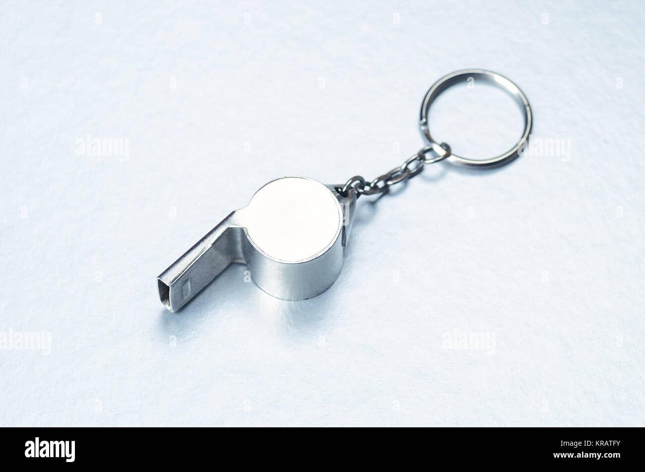 Sports or coaches metal whistle, closeup. Concept refereeing sport on silver ice background. Hockey referee whistle Stock Photo