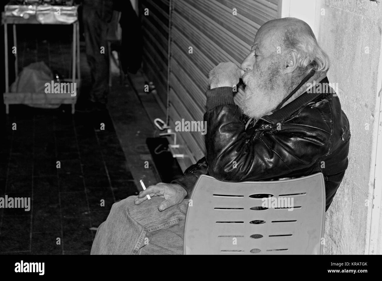 Tired Arab Ambulant in Downtown- 25/04/2017 - Jordan / Amman Sguardi Aridi by Ali Raffaele Matar shot in April 2017 - Sad old man sitting in Al Balad Stock Photo