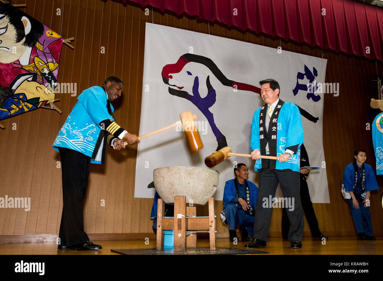 NAVAL AIR FACILITY ATSUGI, Japan (Dec. 13, 2017) Capt. Lloyd B. Mack, (L) Naval Air Facility Atsugi commanding officer, swings a kine (wooden mallet) to pound rice during the annual Japan Maritime Self-Defense Force, Commander, Fleet Air Wing Four mochi-tsuki (rice pounding) event. Mochi-tsuki events in Japan are traditionally held to mark special occasions, especially the New Year. (U.S. Navy Stock Photo