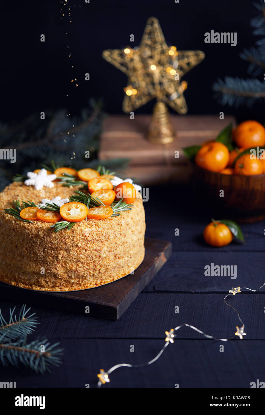 Christmas Honey cake with rosemary and oranges on black background. Stock Photo