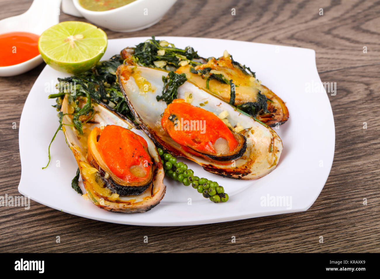 Baked mussels with spinach, lime and cheese Stock Photo Alamy