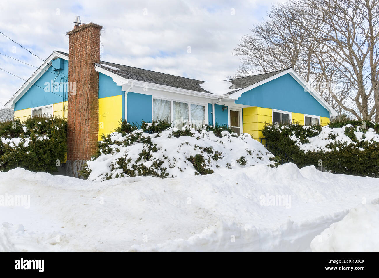 Older bungalow style home buried in snow. Stock Photo