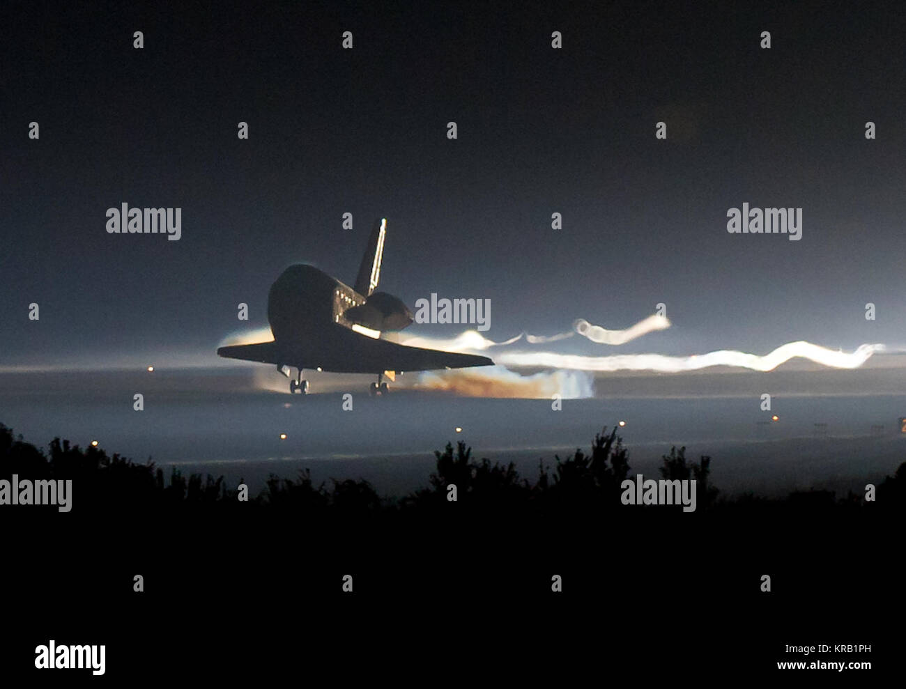 Space shuttle Atlantis (STS-135) touches down at NASA's Kennedy Space Center Shuttle Landing Facility (SLF), completing its 13-day mission to the International Space Station (ISS) and the final flight of the Space Shuttle Program, early Thursday morning, July 21, 2011, in Cape Canaveral, Fla. Overall, Atlantis spent 307 days in space and traveled nearly 126 million miles during its 33 flights. Atlantis, the fourth orbiter built, launched on its first mission on Oct. 3, 1985. Photo Credit: (NASA/Bill Ingalls) STS-135 landing cropped Stock Photo