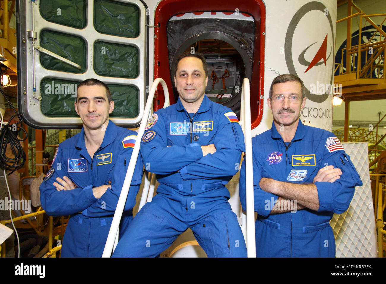 At the Baikonur Cosmodrome in Kazakhstan, Expedition 30 Flight Engineer Anatoly Ivanishin (left), Soyuz Commander Anton Shkaplerov (center) and Expedition 30 Commander Dan Burbank of NASA (right) pose for pictures in front of their Soyuz TMA-22 spacecraft November 9, 2011 as they completed a final inspection of the vehicle in its Integration Facility. The trio are preparing for launch November 14 from Baikonur to the International Space Station.  Credit: NASA/Victor Zelentsov Soyuz TMA-22 crew in front of their spacecraft Stock Photo