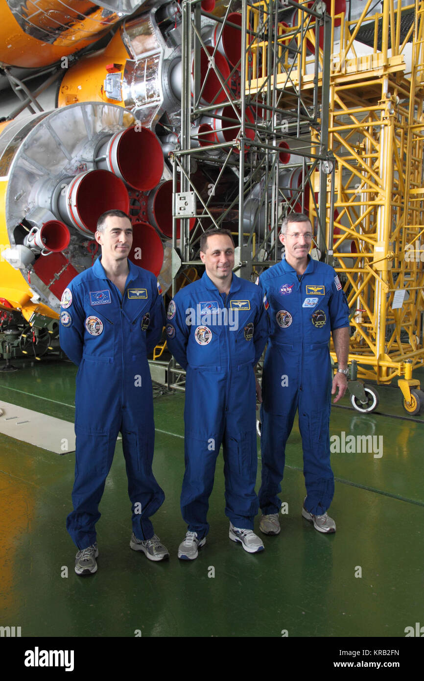 At the Baikonur Cosmodrome in Kazakhstan, Expedition 30 Flight Engineer Anatoly Ivanishin (left), Soyuz Commander Anton Shkaplerov (center) and Expedition 30 Commander Dan Burbank of NASA (right) pose for pictures in front of their Soyuz booster rocket November 9, 2011 as they prepare for launch November 14 on the Soyuz TMA-22 spacecraft from Baikonur to the International Space Station.  Credit: NASA/Victor Zelentsov Soyuz TMA-22 crew in front of their booster rocket Stock Photo