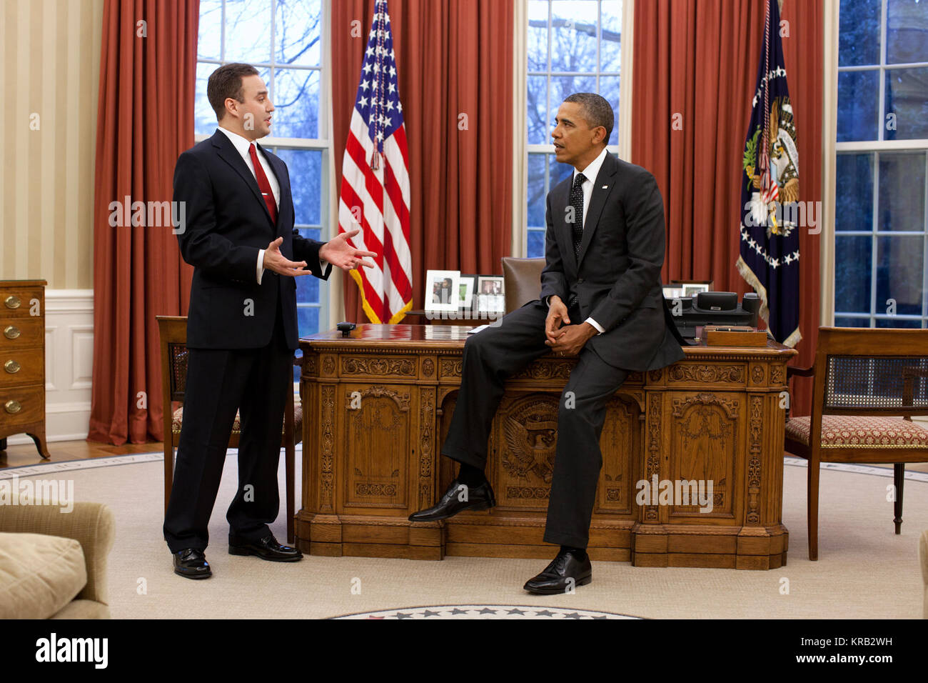 President Barack Obama talks with Matthew Ritsko, the winner of the 2011 Presidential Securing Americans' Value and Efficiency (SAVE) award, in the Oval Office, Jan. 9, 2012. Ritsko, a financial manager at NASA's Goddard Space Flight Center, proposed the space agency create a 'lending library' where specialized space tools and hardware purchased by one NASA organization will be made available to other NASA programs and projects. (Official White House Photo by Pete Souza) This official White House photograph is being made available only for publication by news organizations and/or for personal  Stock Photo