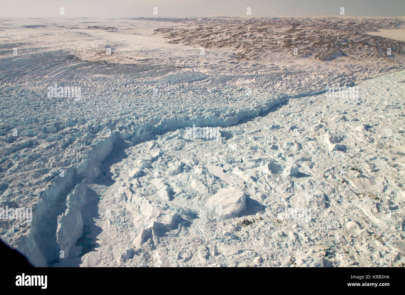 The calving front of the Jakobshavn Glacier in western Greenland, as seen from NASA's P-3B aircraft on April 21, 2012.   Credit: NASA/GSFC/Jefferson Beck  ===========  IceBridge, a six-year NASA mission, is the largest airborne survey of Earth's polar ice ever flown. It will yield an unprecedented three-dimensional view of Arctic and Antarctic ice sheets, ice shelves and sea ice. These flights will provide a yearly, multi-instrument look at the behavior of the rapidly changing features of the Greenland and Antarctic ice.  Data collected during IceBridge will help scientists bridge the gap in p Stock Photo