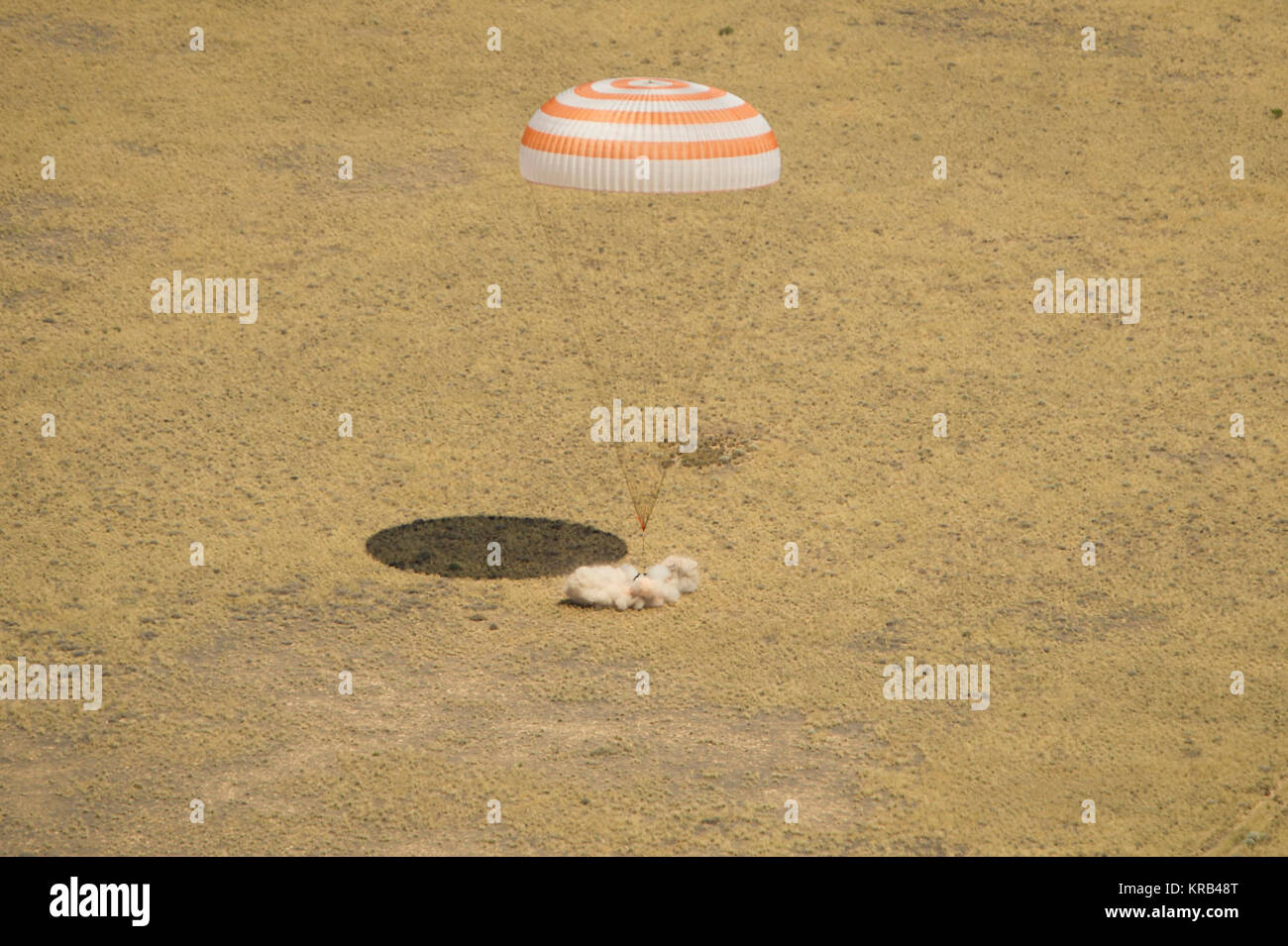 The Soyuz TMA-03M spacecraft is seen as it lands with Expedition 31 Commander Oleg Kononenko of Russia and Flight Engineers Don Pettit of NASA and Andre Kuipers of the European Space Agency in a remote area near the town of Zhezkazgan, Kazakhstan, on Sunday, July 1, 2012.  Pettit, Kononenko and Kuipers returned from more than six months onboard the International Space Station where they served as members of the Expedition 30 and 31 crews. Photo Credit: (NASA/Bill Ingalls) Soyuz TMA-03M capsule lands Stock Photo