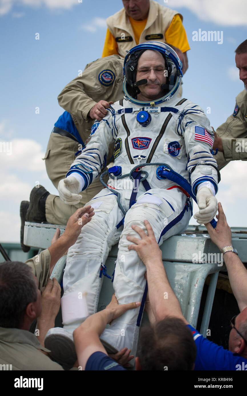 Expedition 31 Flight Engineer Don Pettit of NASA is helped