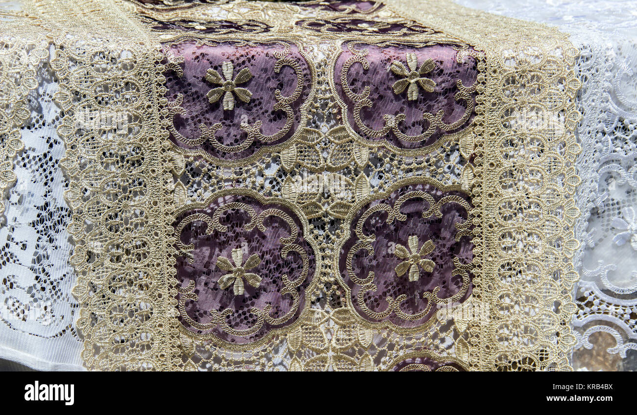 Handmade lace tablecloths decorating a table Stock Photo
