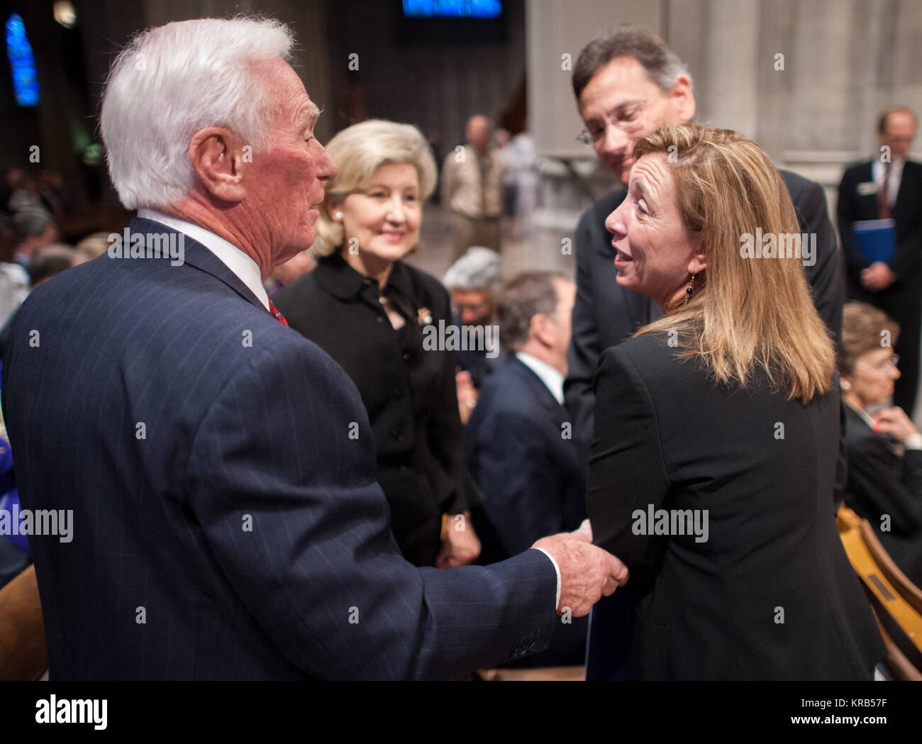 NASA Deputy Administrator Lori Garver, right, shares a moment with Apollo 17 mission commander Gene Cernan, the last man to walk on the moon, left, as U.S. Sen. Kay Bailey Hutchison, R-Texas, center looks on prior to a memorial service celebrating the life of Neil Armstrong, Thursday, Sept. 13, 2012, at the Washington National Cathedral. Armstrong, the first man to walk on the moon during the 1969 Apollo 11 mission, died Saturday, Aug. 25. He was 82. Photo Credit: (NASA/Bill Ingalls) Neil Armstrong public memorial service (201209130006HQ) Stock Photo