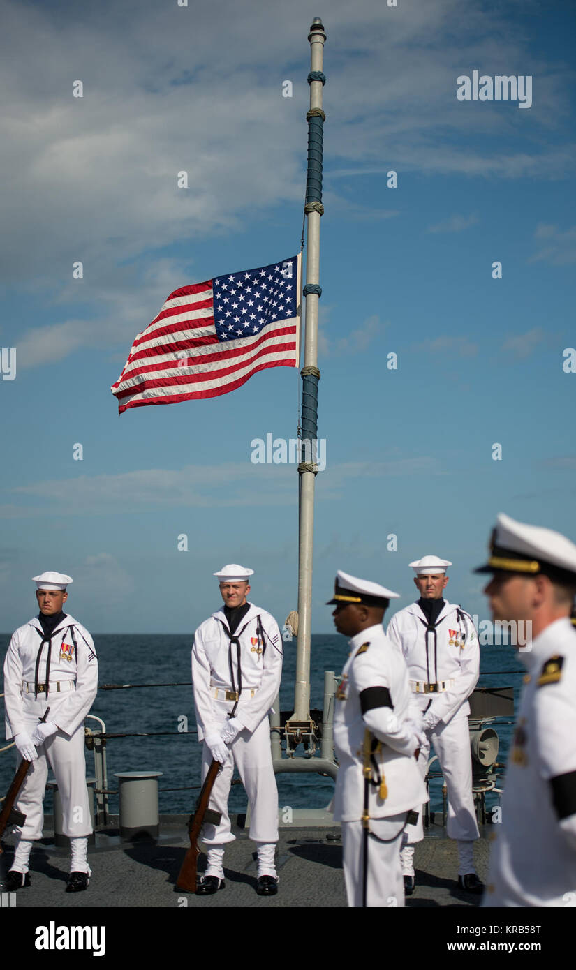 The American flag on the USS Philippine Sea (CG 58) is seen at half-mast during a burial at sea service for Apollo 11 astronaut Neil Armstrong, Friday, Sept. 14, 2012, in the Atlantic Ocean. Armstrong, the first man to walk on the moon during the 1969 Apollo 11 mission, died Saturday, Aug. 25. He was 82. Photo Credit: (NASA/Bill Ingalls) Neil Armstrong burial at sea (201209140007HQ) Stock Photo