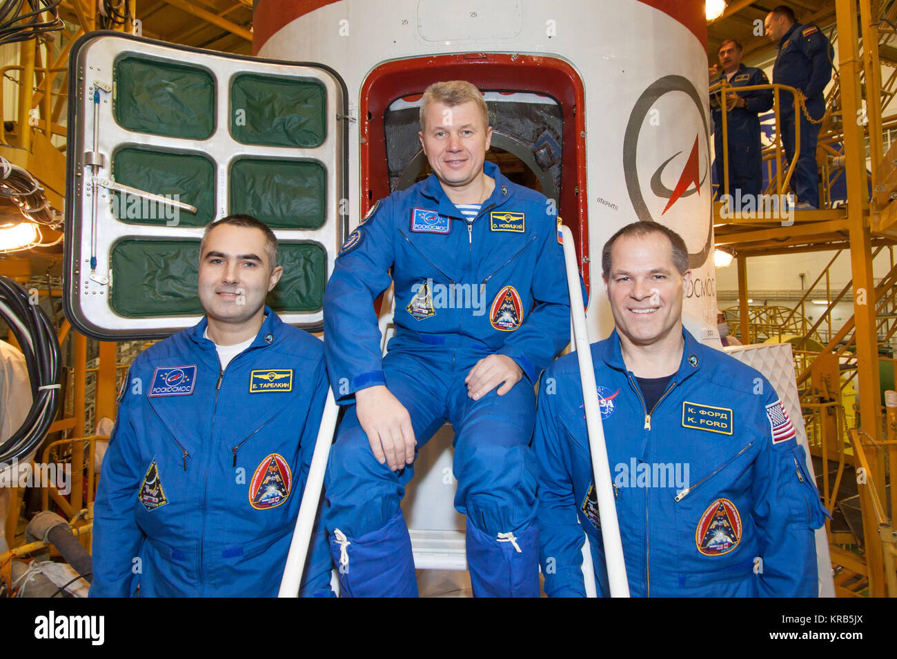 In the Integration Facility at the Baikonur Cosmodrome in Kazakhstan, the Expedition 33/34 prime crew poses for pictures at the hatchway of their Soyuz TMA-06M spacecraft at the completion of their final pre-launch “fit check” dress rehearsal October 18, 2012. Flight Engineer Evgeny Tarelkin (left), Soyuz Commander Oleg Novitskiy (center) and NASA Flight Engineer Kevin Ford (right) will launch October 23 from the Baikonur Cosmodrome for a five-month mission on the International Space Station. NASA/Victor Zelentsov Soyuz TMA-06M crew members in front of the spacecraft Stock Photo