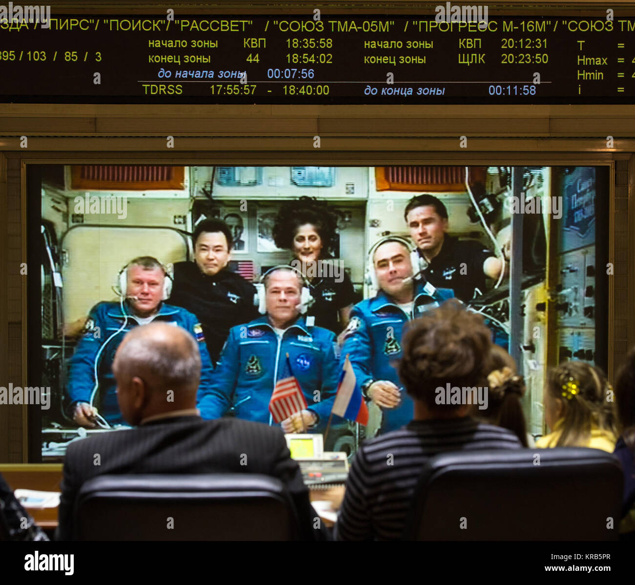 Family of the newly arrived International Station Expedition 33/34 crew members, Russian cosmonaut Oleg Novitskiy, front left, NASA astronaut Kevin Ford, front center, and Russian cosmonaut Evgeny Tarelkin, front right, talk via phone to the crew from the Russian Mission Control Center in Korolev, Russia shortly after the three joined Flight Engineer Aki Hoshide of the Japan Aerospace Exploration Agency, back left, Expedition 33 Commander Sunita Williams of NASA, back center, and Yuri Malenchenko of the Russian Federal Space Agency on Thursday, Oct. 25, 2012. Photo Credit: (NASA/Bill Ingalls)  Stock Photo