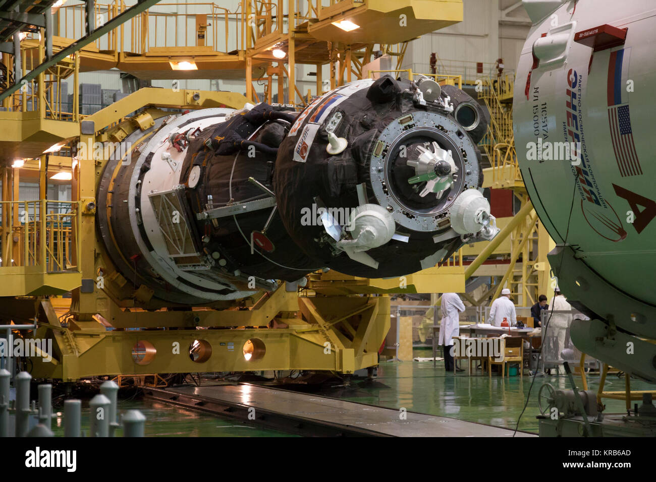 In the Integration Facility at the Baikonur Cosmodrome in Kazakhstan, the Soyuz TMA-07M spacecraft is moved into place for its encapsulation into the upper stage of the Soyuz booster Dec. 12, 2012 as preparations continue for the launch of the Expedition 34/35 crew. The vehicle will be rolled to the launch pad at Baikonur Dec. 17 in advance of the Dec. 19 launch of NASA Flight Engineer Tom Marshburn, Soyuz Commander Roman Romanenko and Flight Engineer Chris Hadfield of the Canadian Space Agency for a five-month mission on the International Space Station. Photo Credit: NASA/Victor Zelentsov Soy Stock Photo