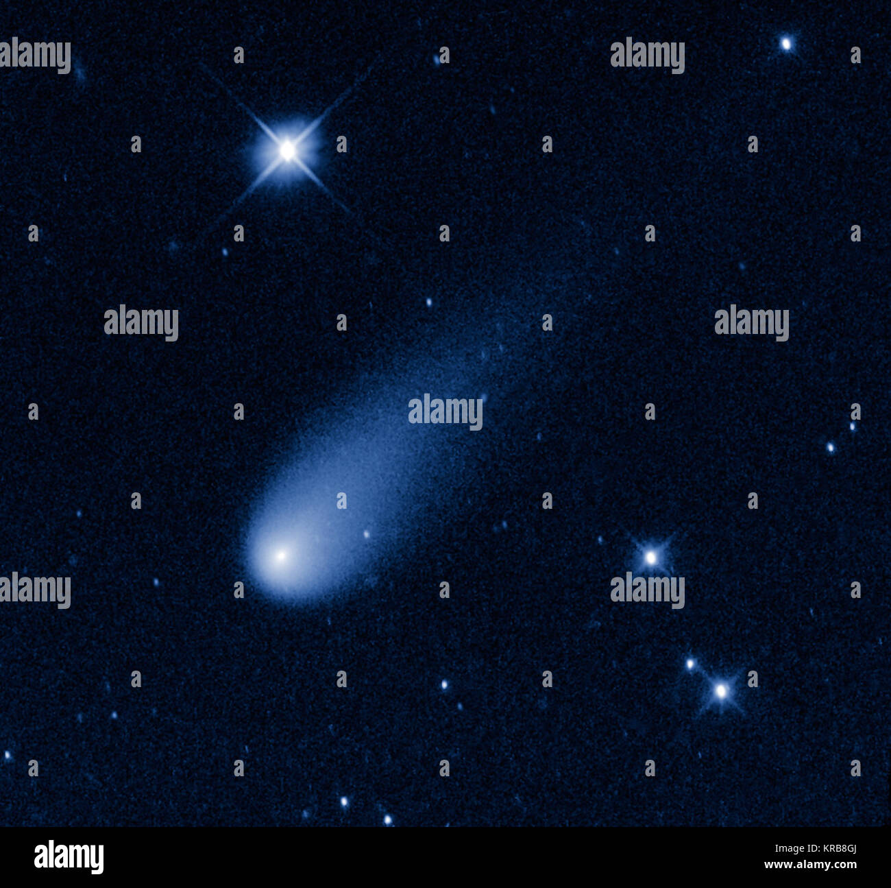 Superficially resembling a skyrocket, Comet ISON is hurtling toward the Sun at a whopping 48,000 miles per hour. Its swift motion is captured in this image taken May 8, 2013, by NASA's Hubble Space Telescope. At the time the image was taken, the comet was 403 million miles from Earth, between the orbits of Mars and Jupiter. Unlike a firework, the comet is not combusting, but in fact is pretty cold. Its skyrocket-looking tail is really a streamer of gas and dust bleeding off the icy nucleus, which is surrounded by a bright, star-like-looking coma. The pressure of the solar wind sweeps the mater Stock Photo