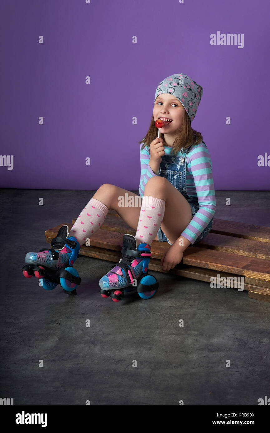 Sporty pretty teen girl loves sports.beautiful little girl eats candy.  children's sports fashion Stock Photo - Alamy