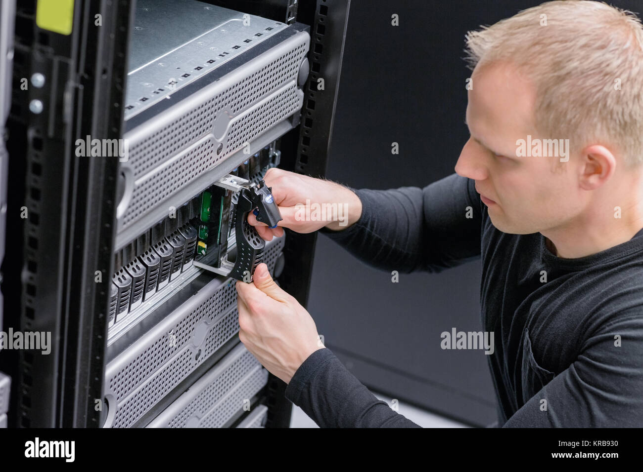 IT Consultant insert SAN hard drive Stock Photo