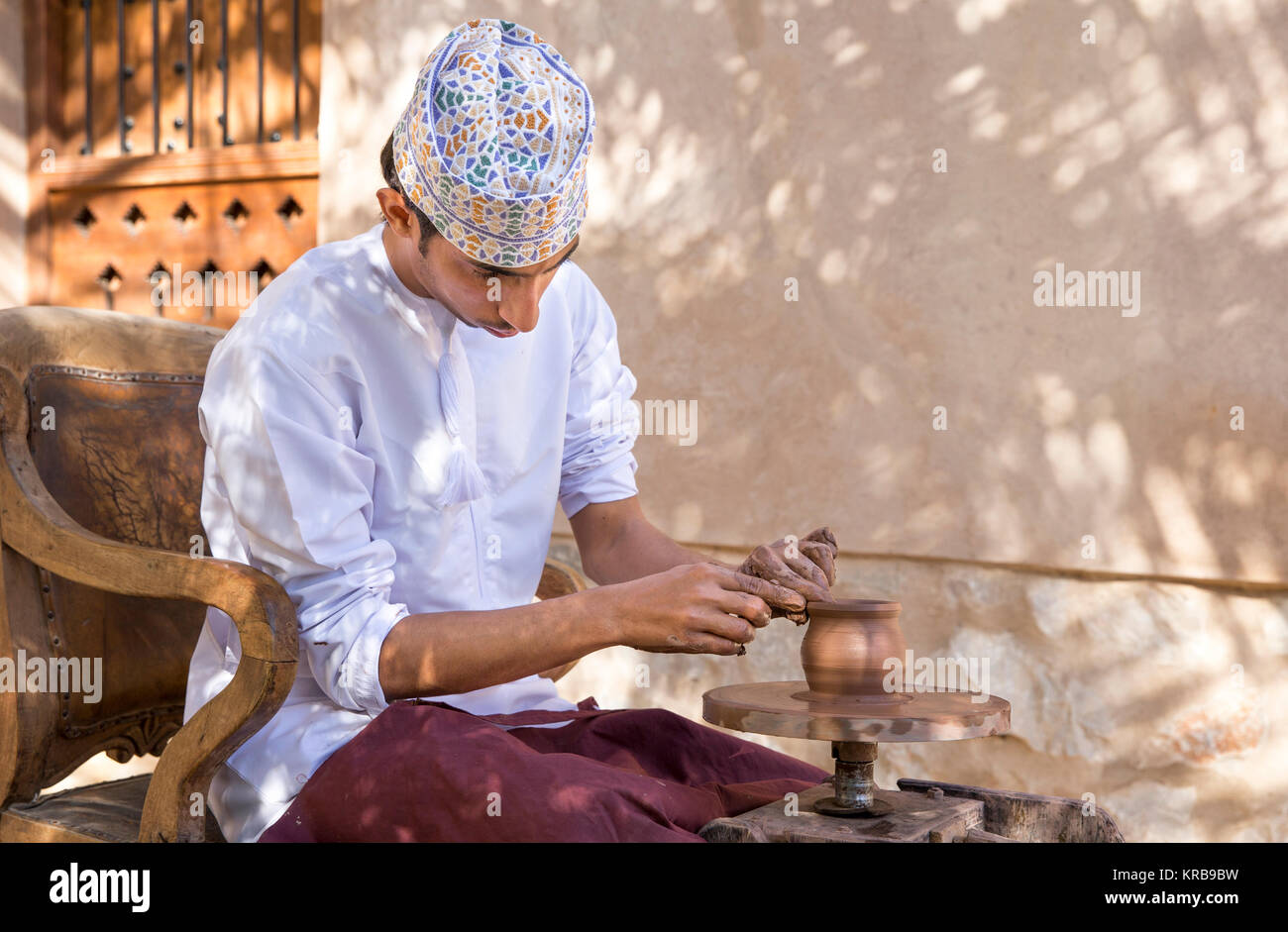 Nizwa, Oman, December 1st, 2017: omani man making pottery Stock Photo