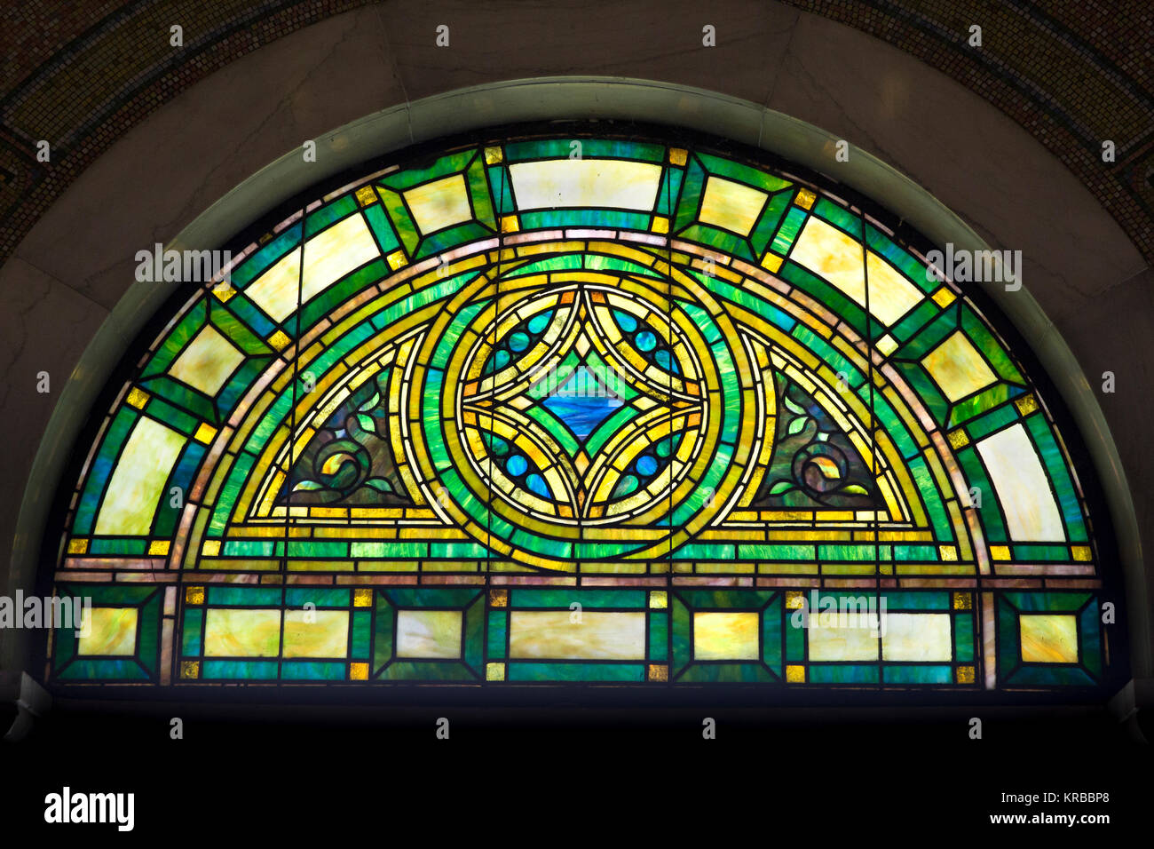 Stain glass window transom light in the historic 1908 Lakewood Memorial Chapel in Minneapolis, Minnesota,  The chapel was designed by architect Harry  Stock Photo