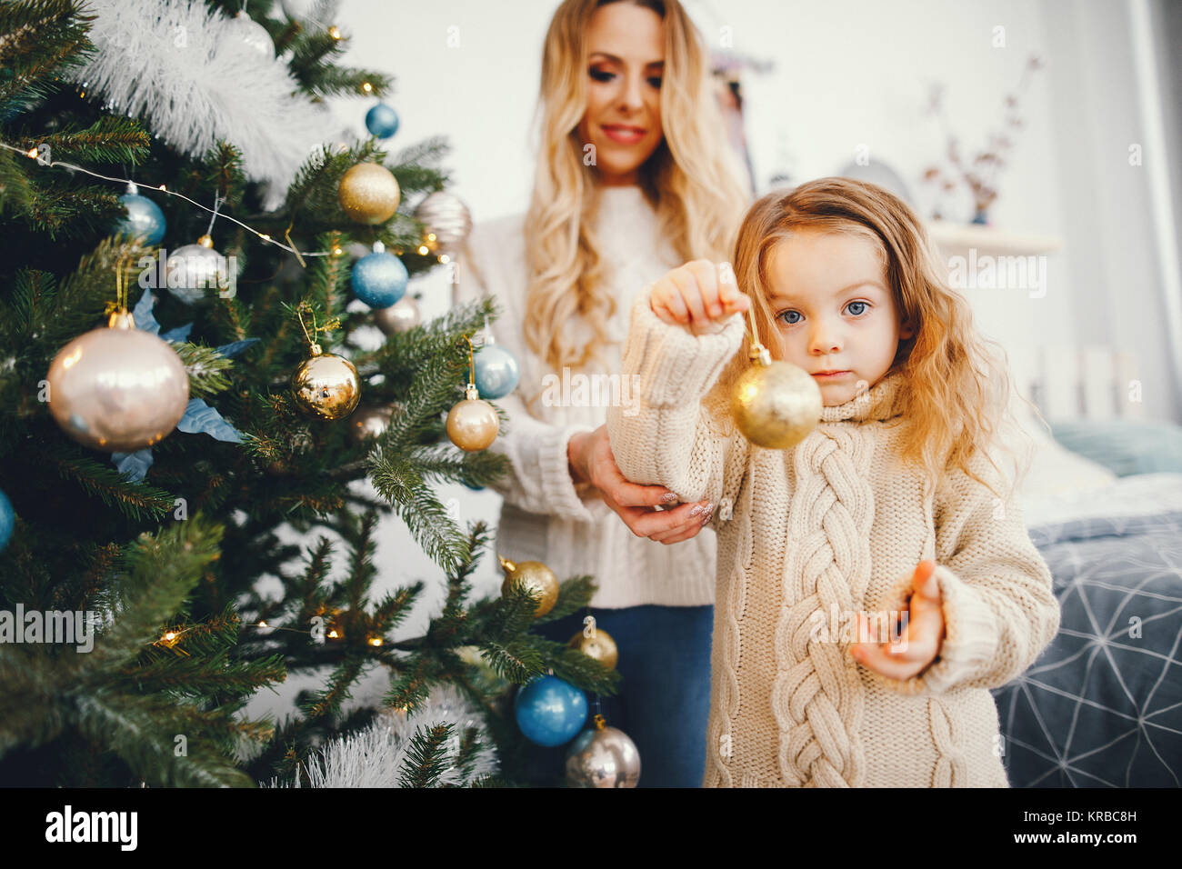 mother and daughter decorating the tree Stock Photo - Alamy